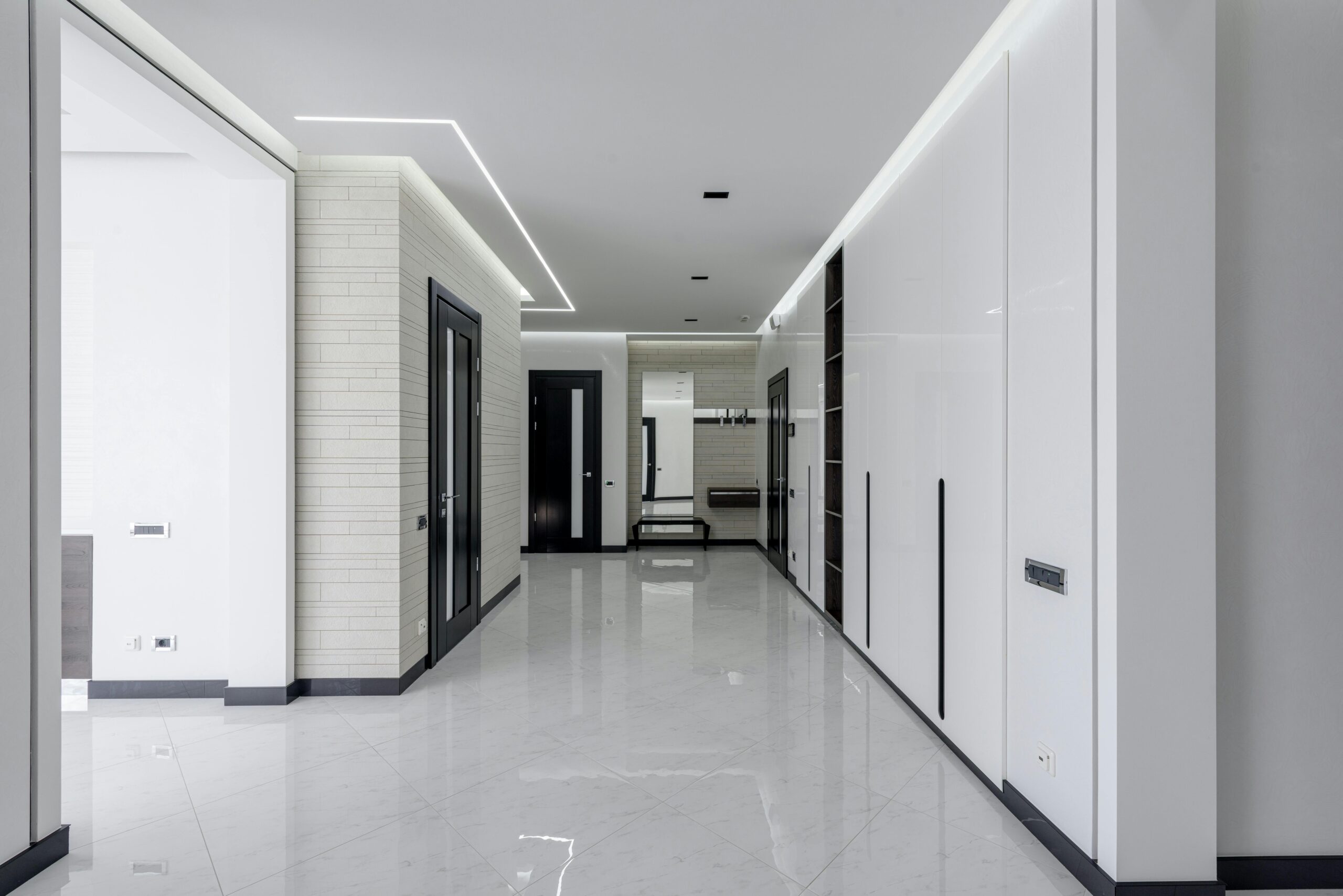 A sleek and bright empty corridor with modern minimalist architecture features and LED lighting.